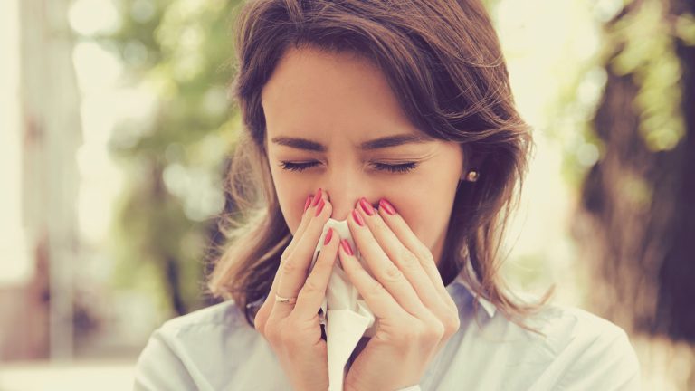 Mujer con un pañuelo en la nariz - Infecciones respiratorias